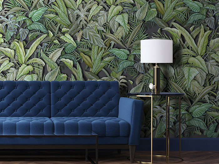 Tropical wallpaper with composition of exotic leaves in various shades of green, on a grey background