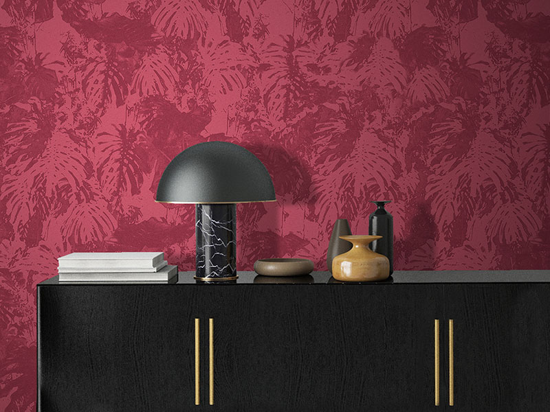 Living room with wallpaper in shades of red with texture of exotic leaves, fabric effect