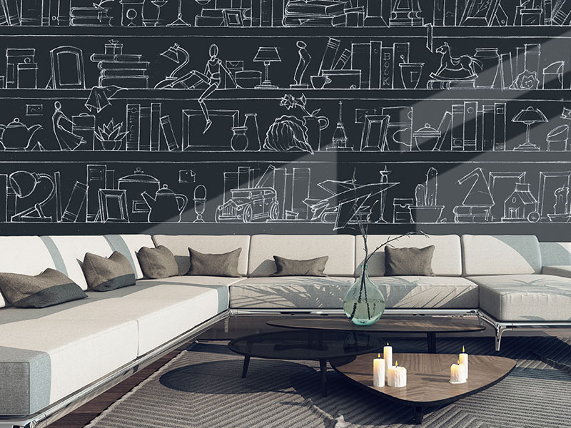 Chalkboard effect wallpaper with bookcase design on a black background covering a living room