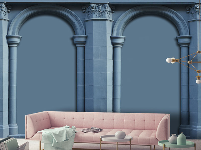 Carta da parati blu a tema architettonico effetto 3d con arcate, in un salotto moderno