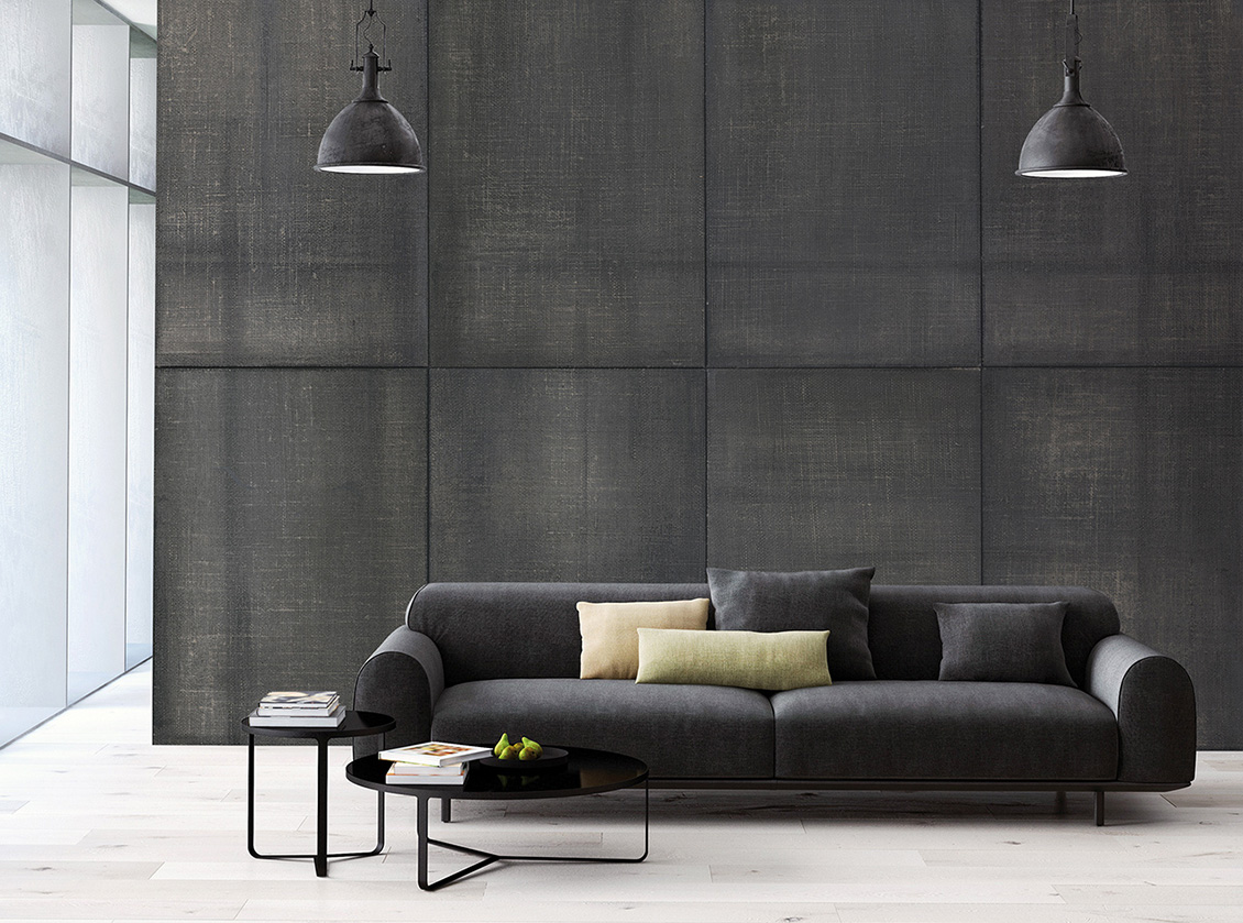 Industrial style wallpaper with textures in shades of grey which furnishes a modern living room